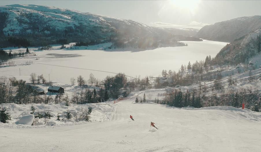 Skifører med fjellen som font , ljoslandskisenter, vinter