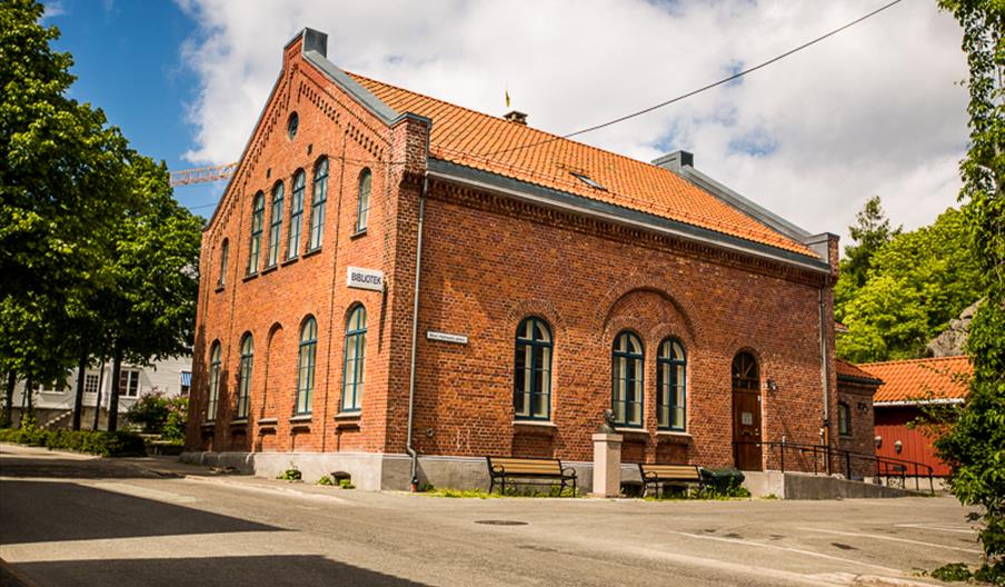 Stor, rød murbygning i Grimstad sentrum.