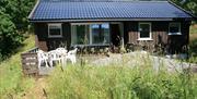 liten brun utleiehytte på Sandaa på Tromøy