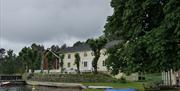 canoes on the grass in front of the main building on Furøya close to Tvedestrand