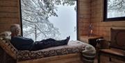 Man looking out the window on a winter view
